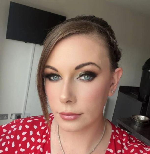 Woman with smoky eye makeup and red polka dot shirt.