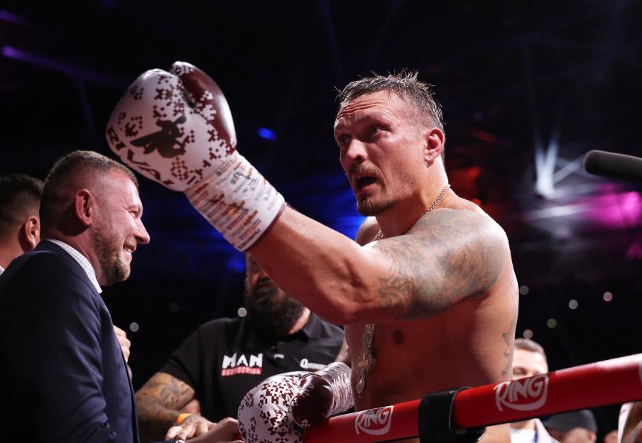 Oleksandr Usyk celebrating a boxing victory.