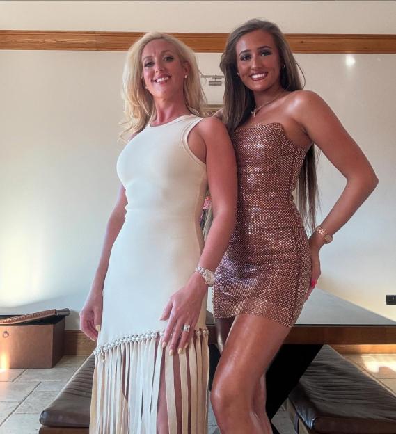 Two women in party dresses.
