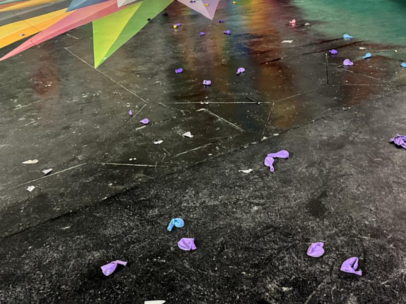 Deflated balloons litter a floor.