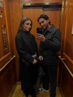 Couple taking a selfie in an elevator.