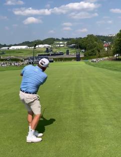 Golfer putting on a green.