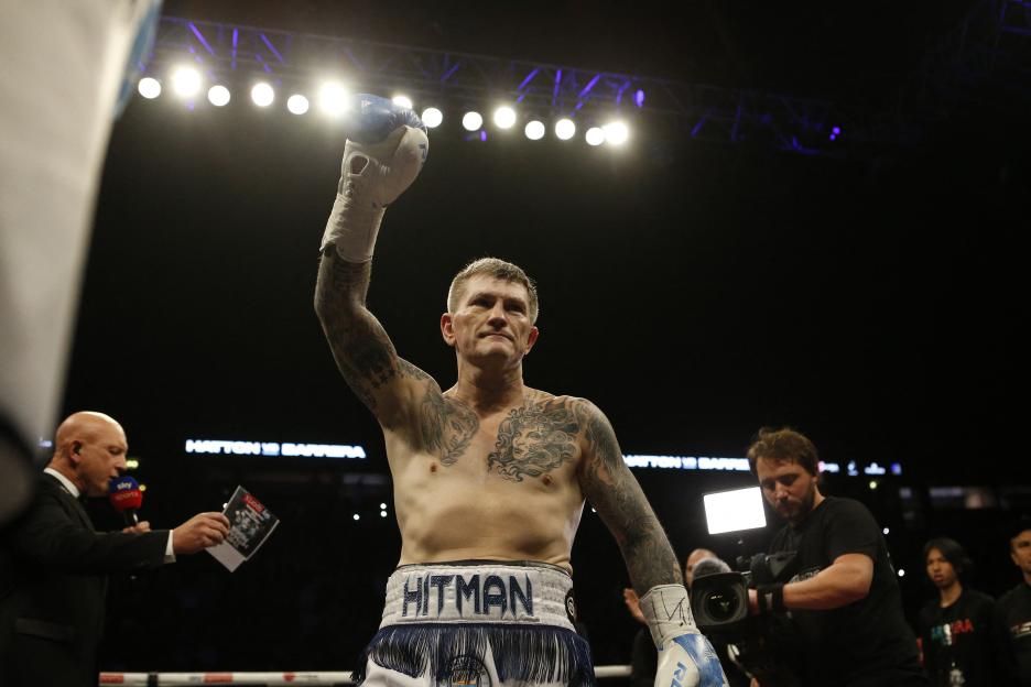 Ricky Hatton raises his arm in victory after a boxing match.