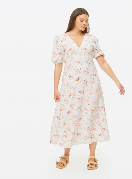 Woman in a white floral midi dress.