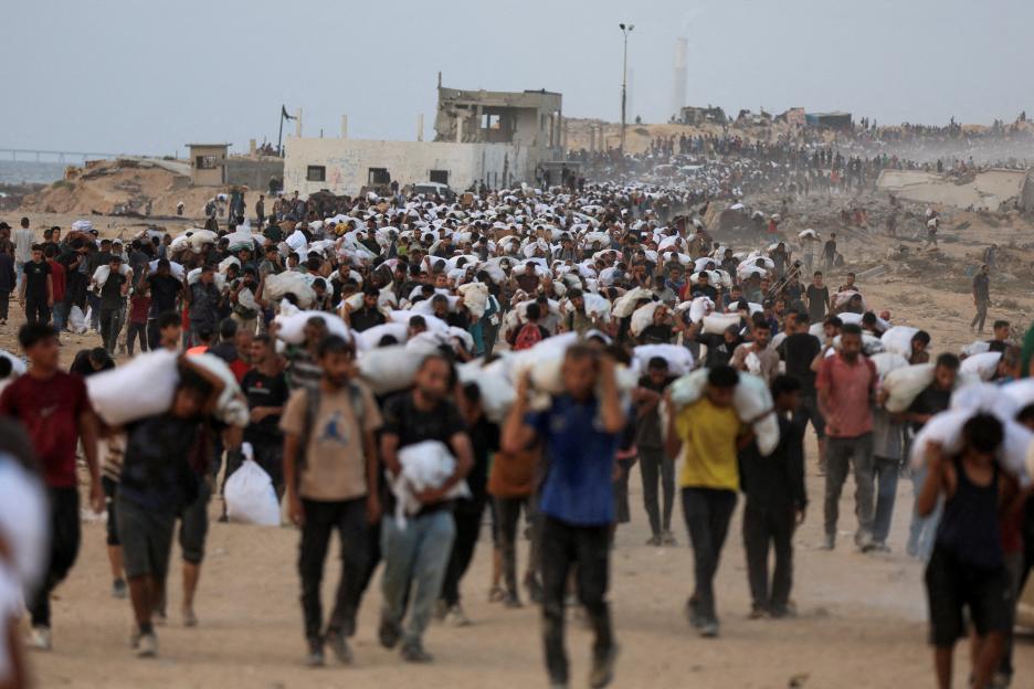 Palestinians carrying aid supplies in Gaza.