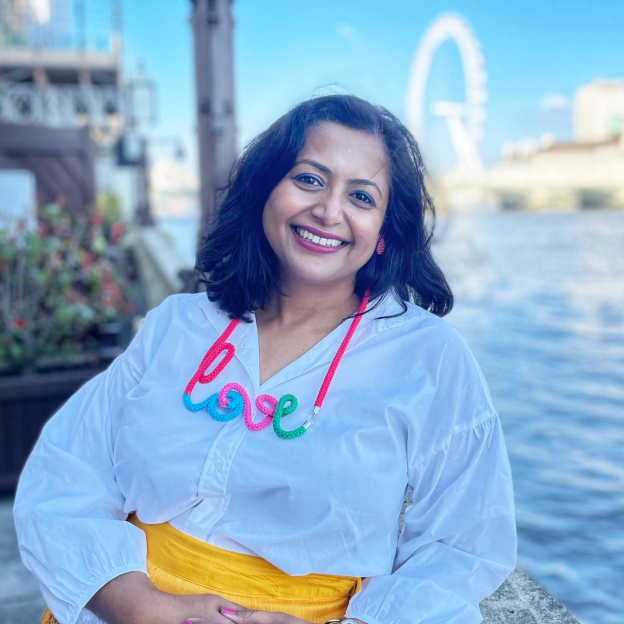 Woman wearing a white shirt and yellow skirt with a colorful