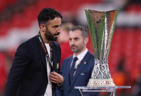 Ruben Amorim, manager of Manchester United, looking dejected near the UEFA Europa League trophy.