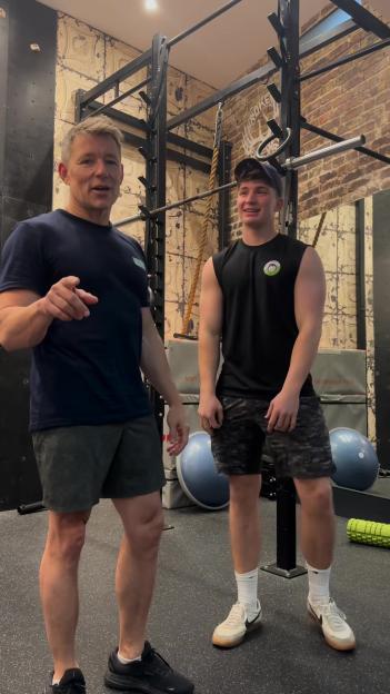 Ben Shephard and his son working out in a gym.