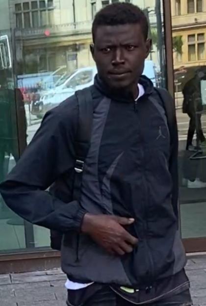 Photo of a man wearing a dark jacket and backpack.