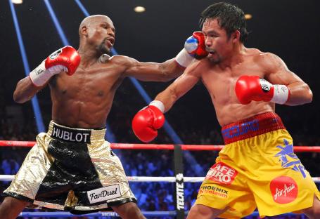 Floyd Mayweather Jr. landing a punch on Manny Pacquiao during a boxing match.
