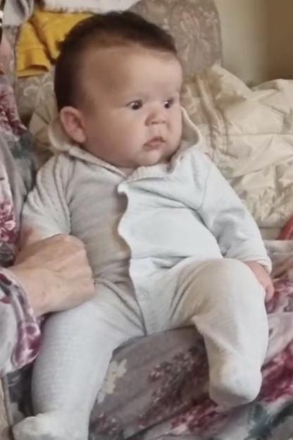 Large baby sitting on a lap.