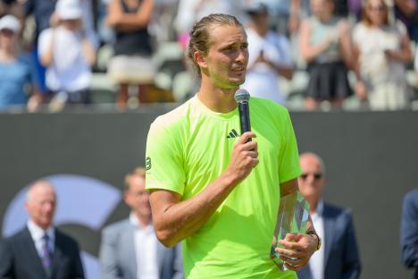 Alexander Zverev of Germany speaks to fans after a tennis match.