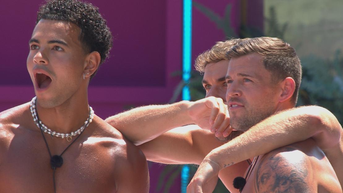 Three shirtless men reacting to something.