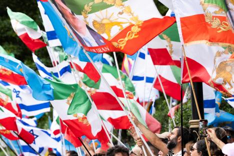 Protestors waving flags outside the Iranian embassy.
