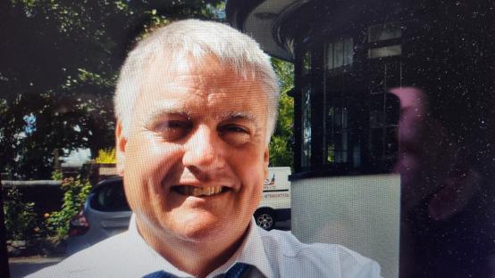 Photo of a smiling man with gray hair.