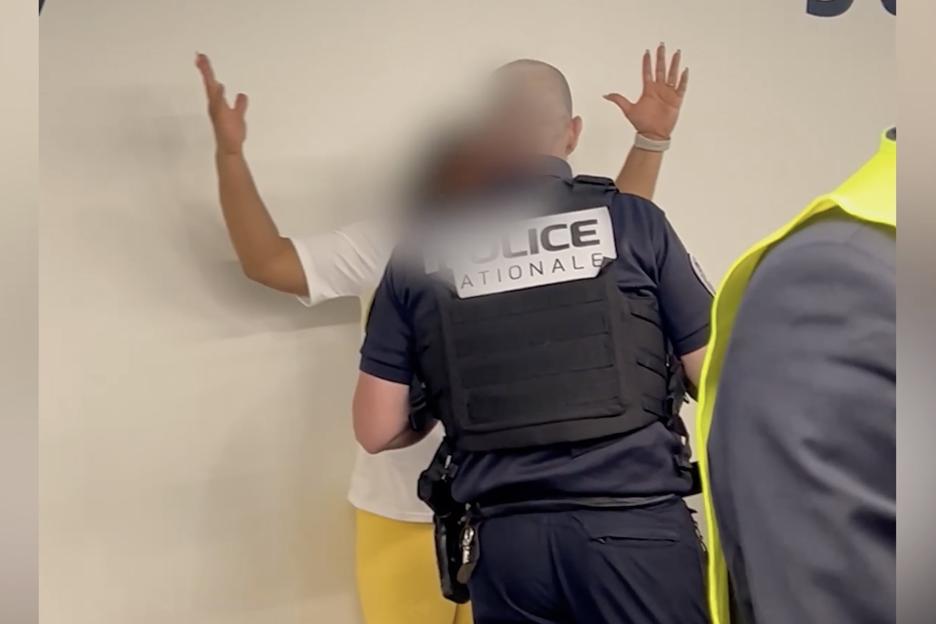Airport security detaining a disruptive passenger.