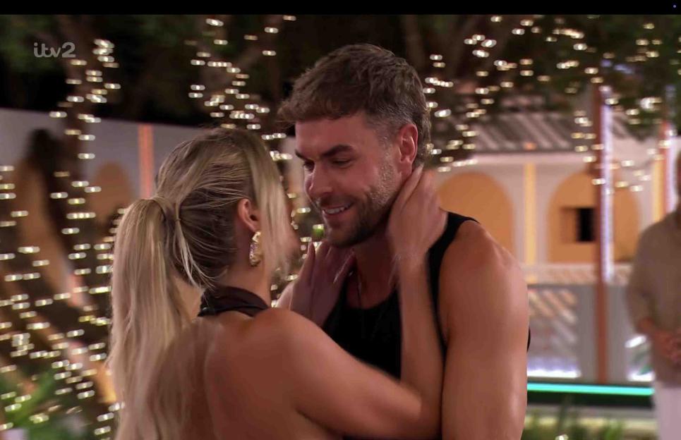 Couple embracing at night.