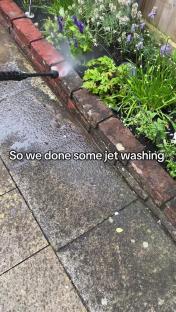Jet washing a patio.