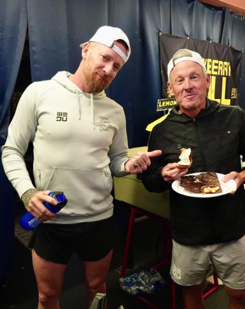 Wiggins and Armstrong holding pastries.