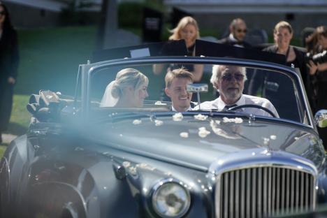 Martin Odegaard and Helene Spilling leave their wedding in a car.