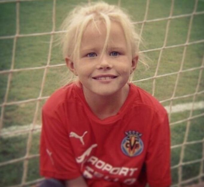Girl in red soccer jersey.
