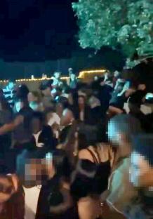 A large group of students at a noisy party.