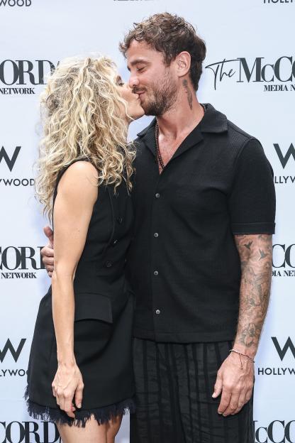 AnnaLynne McCord and Danny Cipriani kissing at an Emmy nomination celebration.