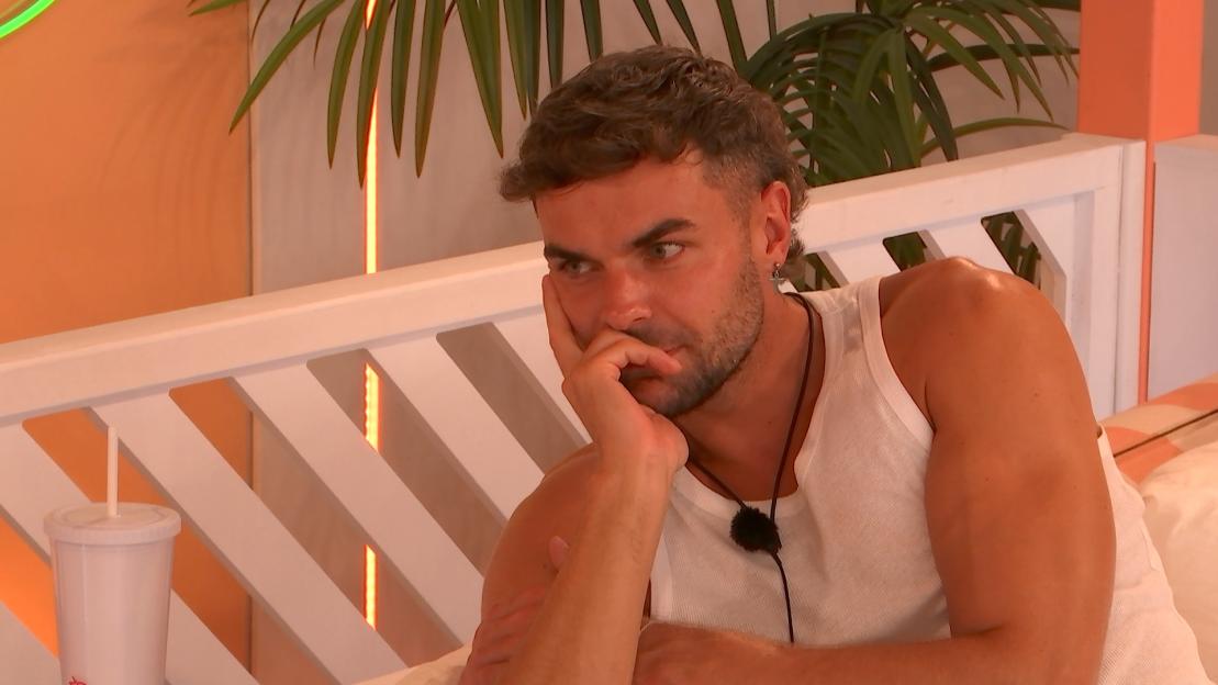 Harry from Love Island looking pensive.