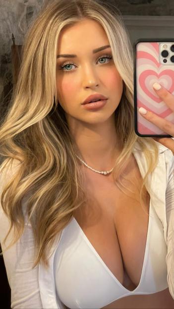 a woman taking a selfie with a phone that has a heart on it