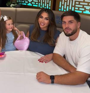 Lauren Goodger and Charles Drury at dinner with a young girl.
