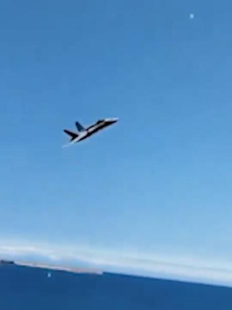Jet flying over the ocean.