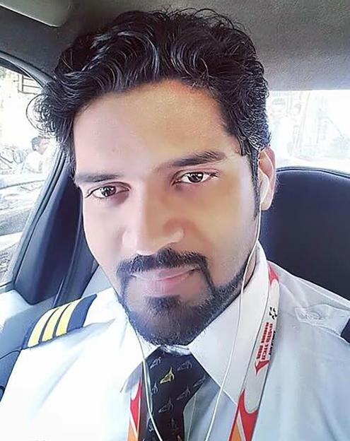 Pilot wearing sunglasses and a face mask.