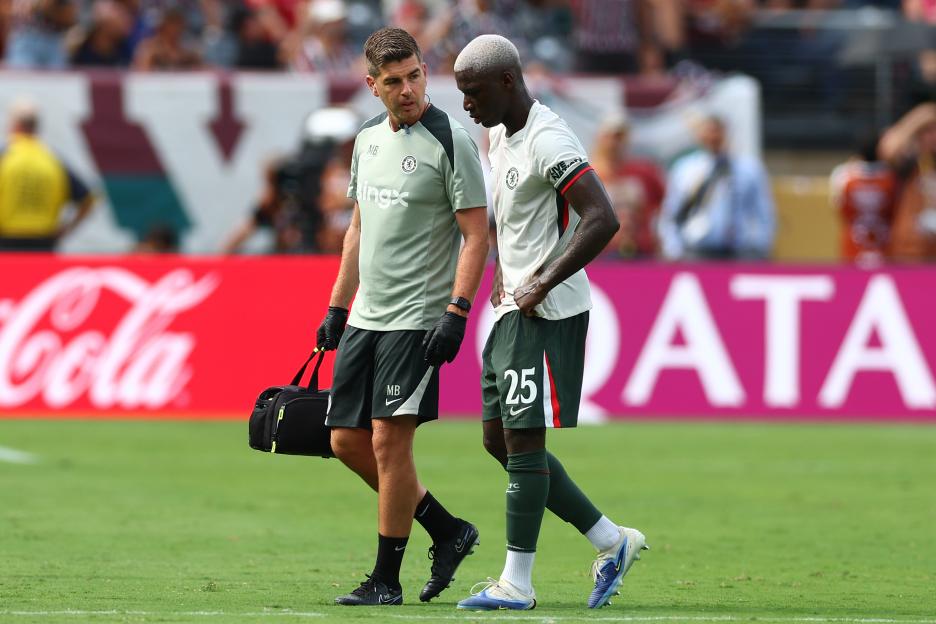 Moises Caicedo of Chelsea FC assisted by a trainer.