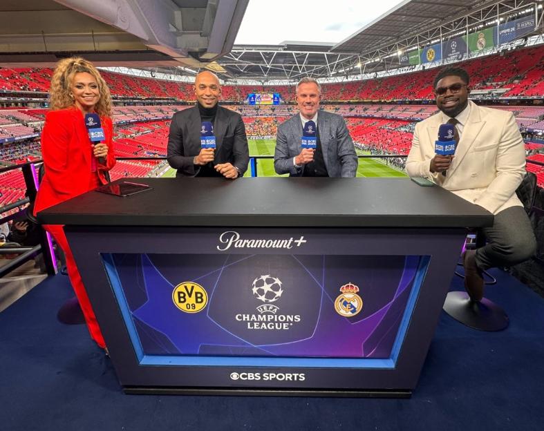 Four sportscasters at a Champions League game.