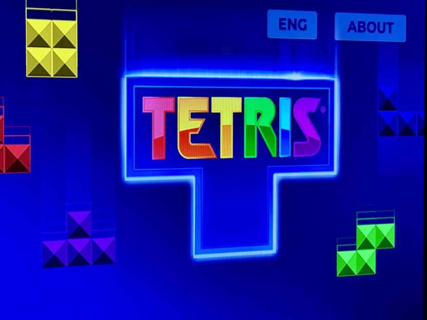Tetris game logo with multicolored blocks.