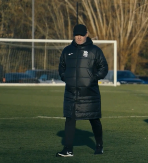 Wayne Rooney on a soccer field.