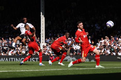 Alex Iwobi scoring a goal during a Fulham FC and Liverpool FC soccer match.