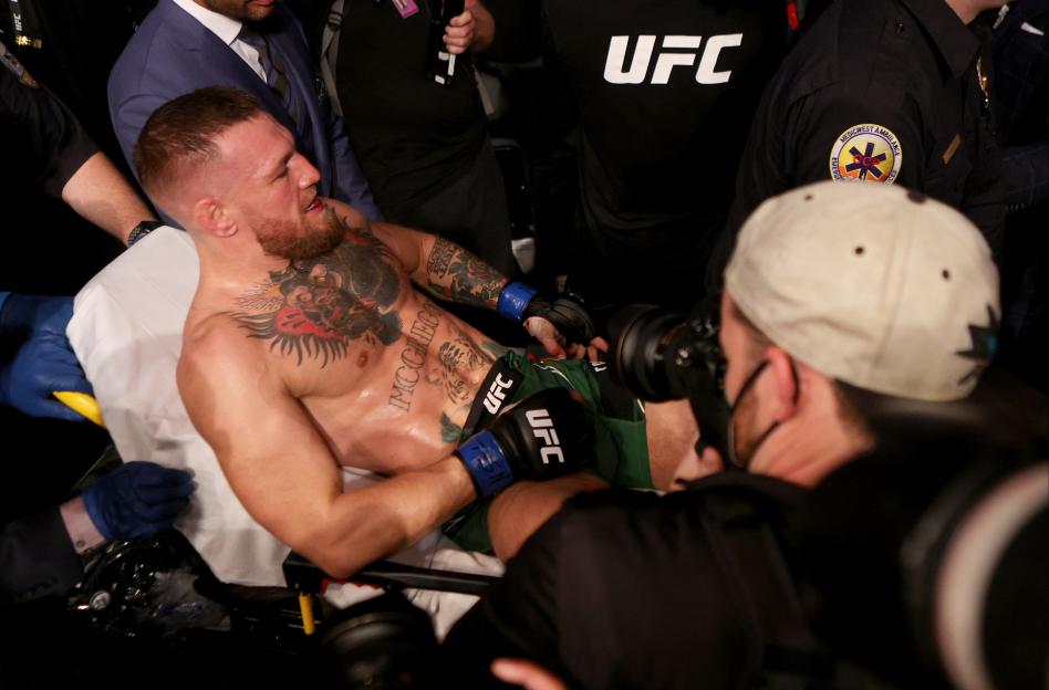 Conor McGregor reacting to a TKO loss in a UFC match.