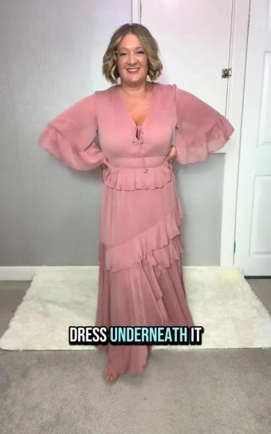 Woman modeling a pink tiered maxi dress.