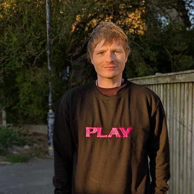 Ty Jones, an Ed Sheeran lookalike, wearing a black sweatshirt with