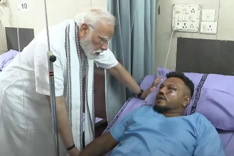 Prime Minister Narendra Modi visiting the sole survivor of the Air India Flight 171 crash in an Ahmedabad hospital.