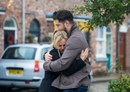 Adam Barlow and Sarah Barlow embracing in a scene from Coronation Street.