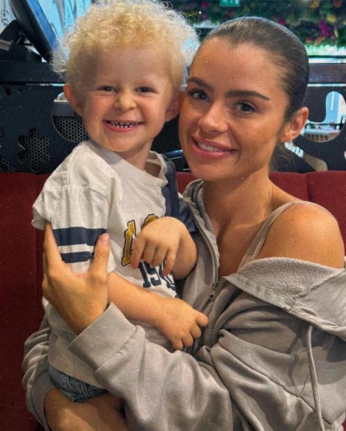 A mother holding her young son.