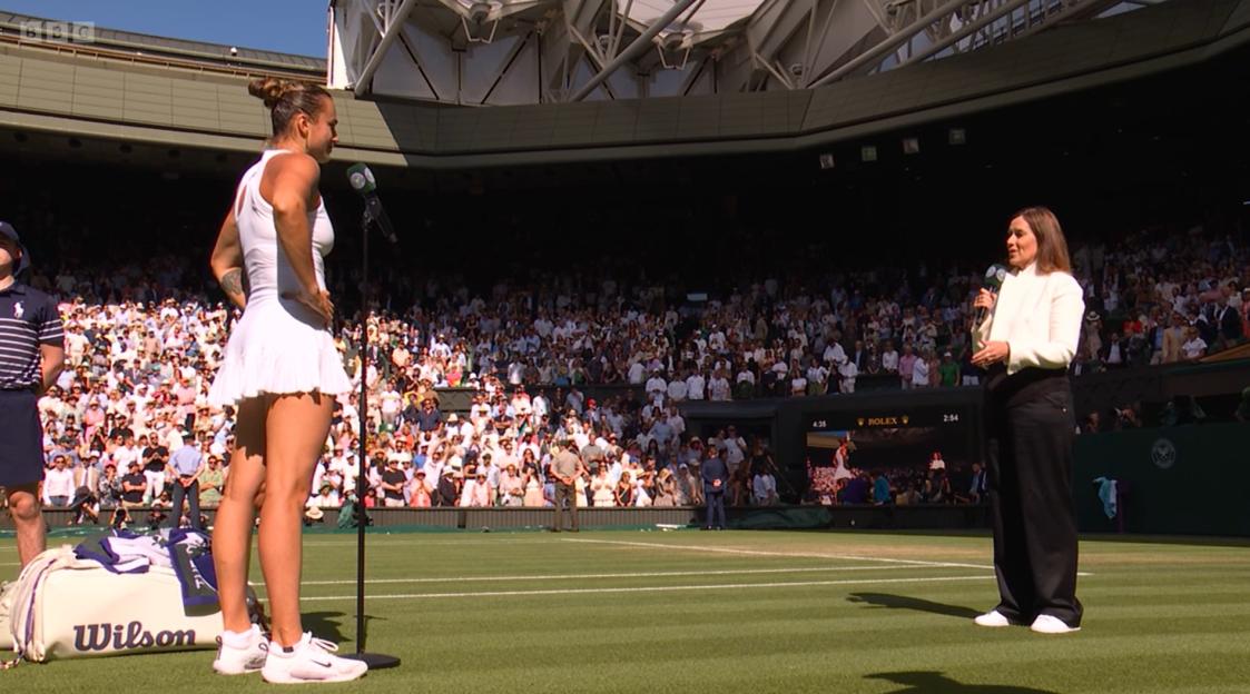 Aryna Sabalenka at Wimbledon, being interviewed on court.