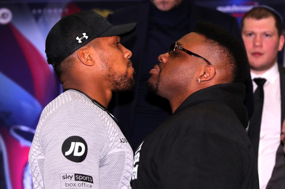 Anthony Joshua and Jarrell Miller facing off at a press conference.