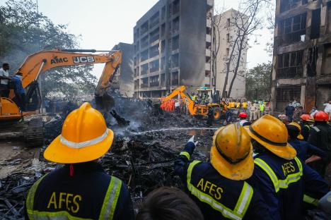 Aftermath of a plane crash, showing wreckage and emergency responders.