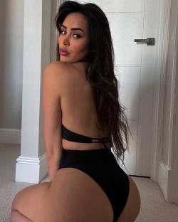 Marnie Simpson in a black swimsuit.
