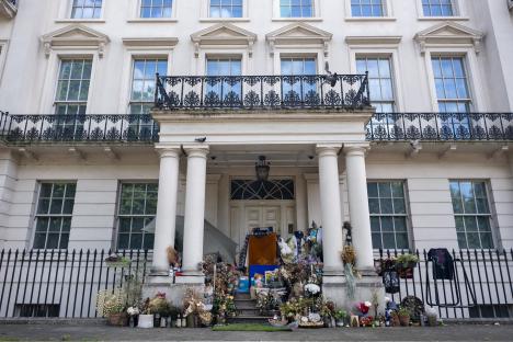 Makeshift home on the doorstep of a London building, illustrating social disparity.