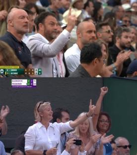 Spectators cheering at a tennis match.