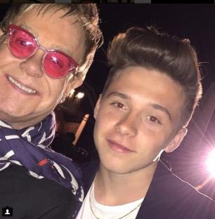 Brooklyn Beckham with Elton John at a Burberry event.